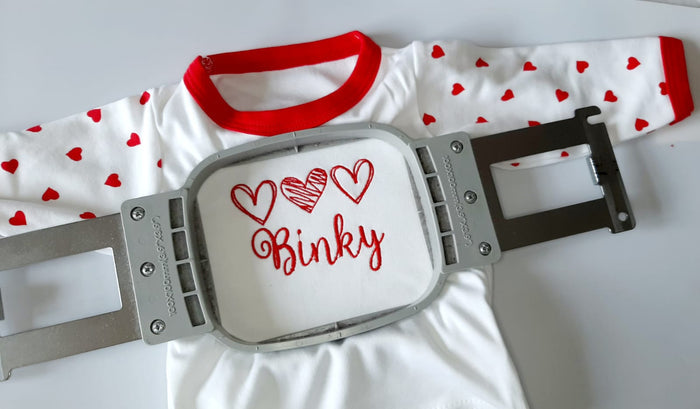 Baby binkie with red hearts and 'Binky' text on a white background