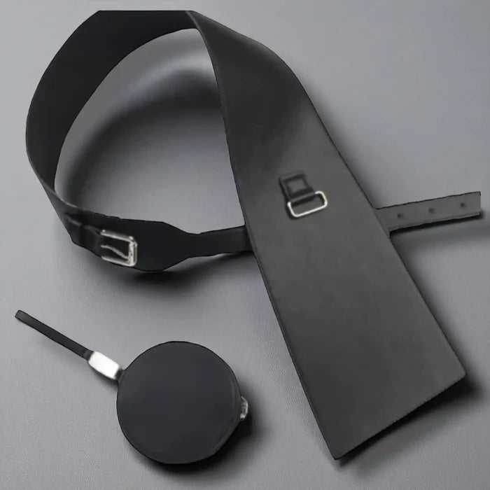 Flat lay of black asymmetric waist belts with mini bag
