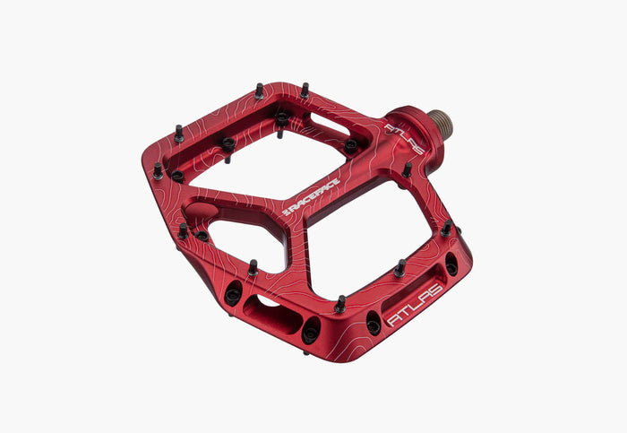 Red bicycle pedal with 'Atlas' branding on a white background