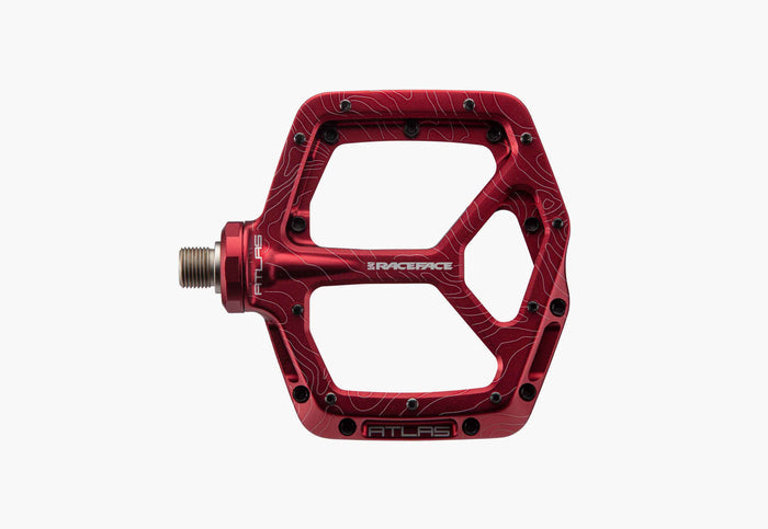 Red bicycle pedal with 'RACEFACE' branding on a white background
