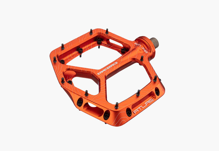 Orange bicycle pedal with brand logo on a white background
