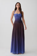 Woman wearing a chocolate and blue ombre pleated halter midi dress.