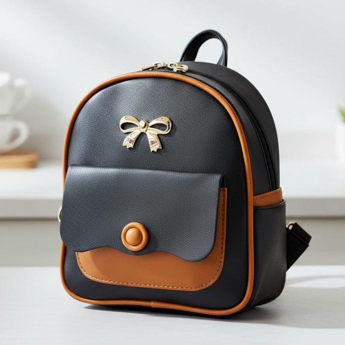 on counter Black Brown Trim Mini Backpack with gold bow detail and adjustable straps / one size/ women's