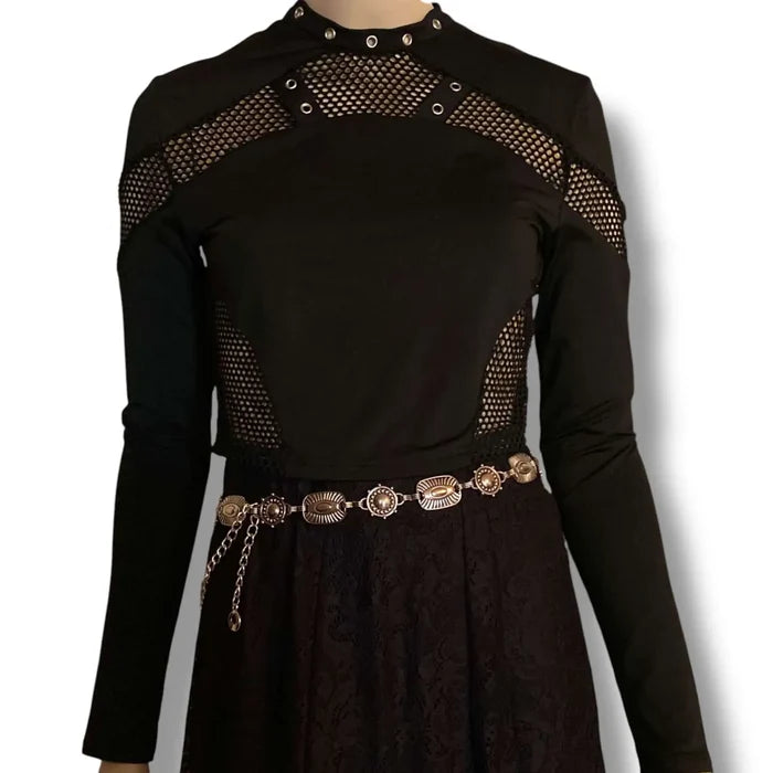 Black cut out mesh studs cropped top with fishnet panel sleeves, silver grommet neckline straps, and keyhole back button closure, women’s fitted size large