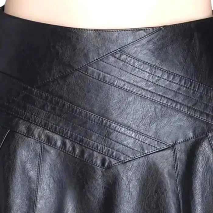close up of embroidered waist panel on faux leather midi skirt