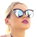 woman wearing pair of Black Silver Mirror Oversized Cat Eye Sunglasses with UV400 lenses, full rim frame, and thin temples