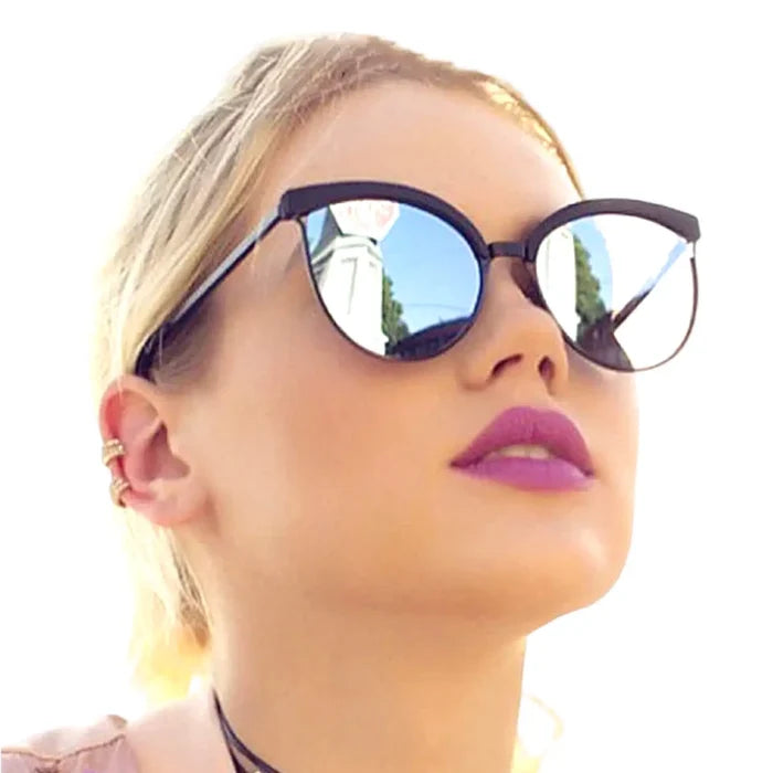 woman wearing pair of Black Silver Mirror Oversized Cat Eye Sunglasses with UV400 lenses, full rim frame, and thin temples