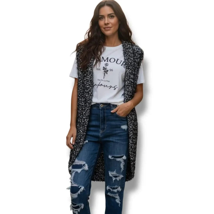 Black and white marled chunky fuzzy knit sleeveless cardigan vest with open front, rolled collar, and rounded high-low shirttail hem in sizes small and medium