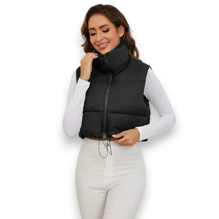 model wearing black cropped puffer vest with tall collar, front zip