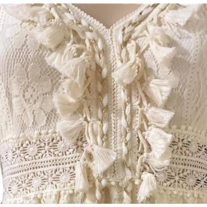 Front view of boho western summer midi dress with pom pom details