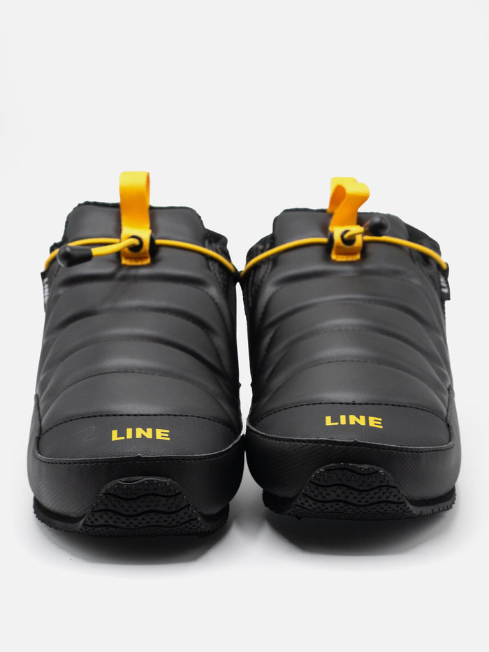 Pair of black shoes with yellow accents and 'LINE' branding on a white background