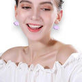 white cartoon cloud drop earrings on model