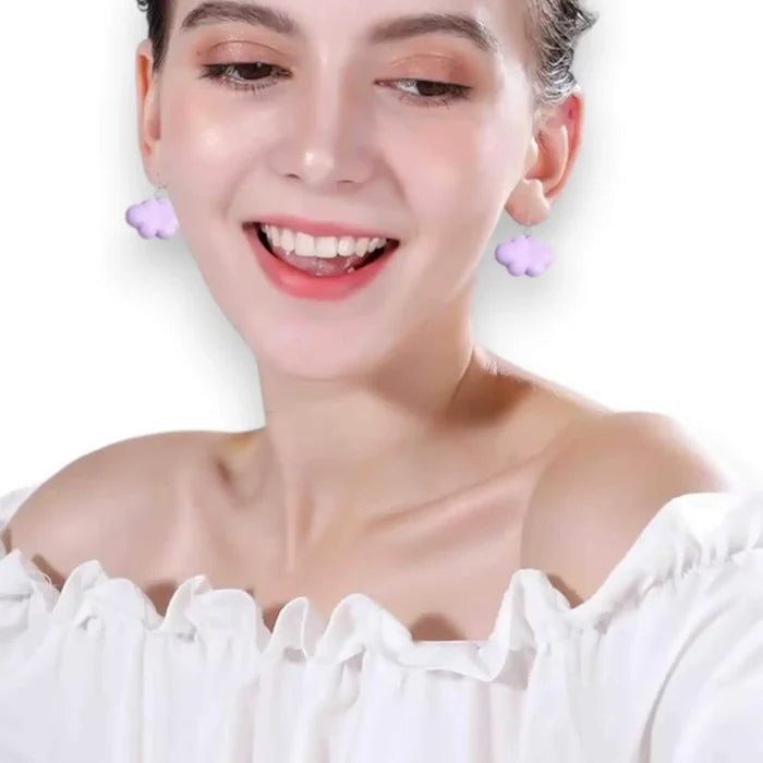 white cartoon cloud drop earrings on model