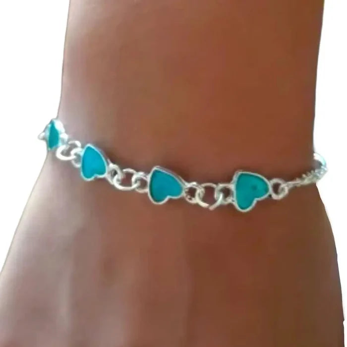 Charming hearts glow in the dark anklet with silver dual chain and glowing blue heart charms – rave, festival, and beach party body jewelry.