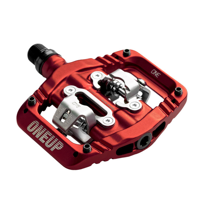 Red bicycle pedal with metallic components on a white background