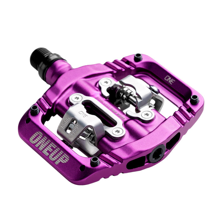 Purple bicycle pedal with silver platform on a white background
