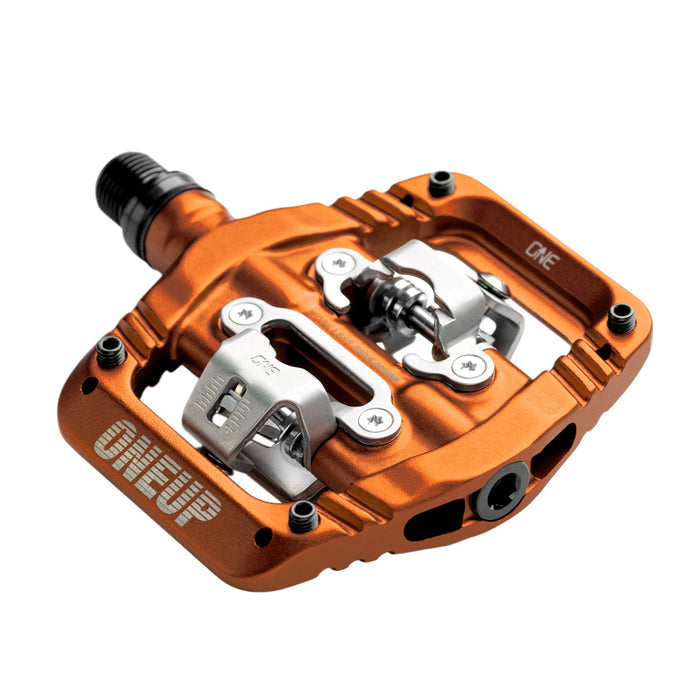 Orange bicycle pedal with metallic components on a white background