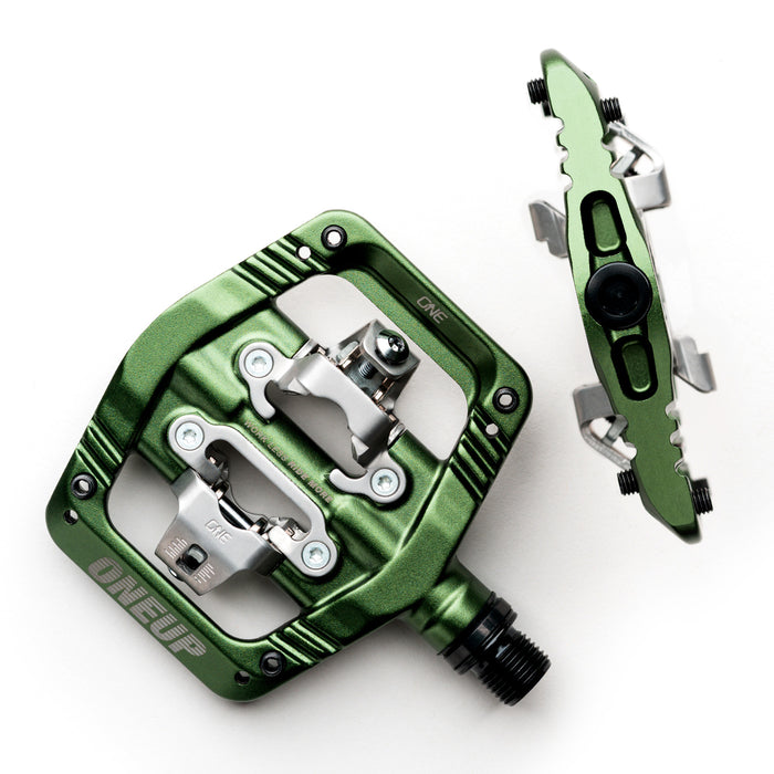 Green and silver bicycle pedal on a white background