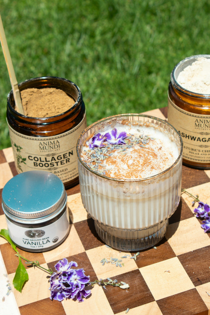Jars of skincare products on a checkered surface with grass in the background