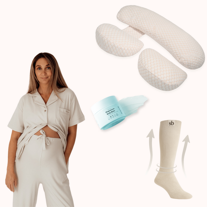 Complete Sleep Bundle: mum in grey maternity pyjamas with pregnancy pillow, body balm and compression socks
