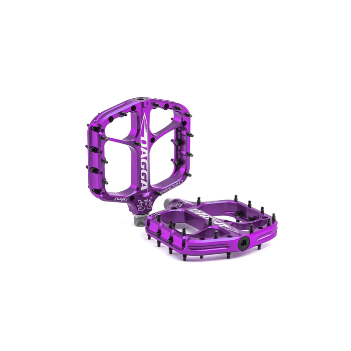 Purple bicycle pedal with 'Dagga' branding on a white background