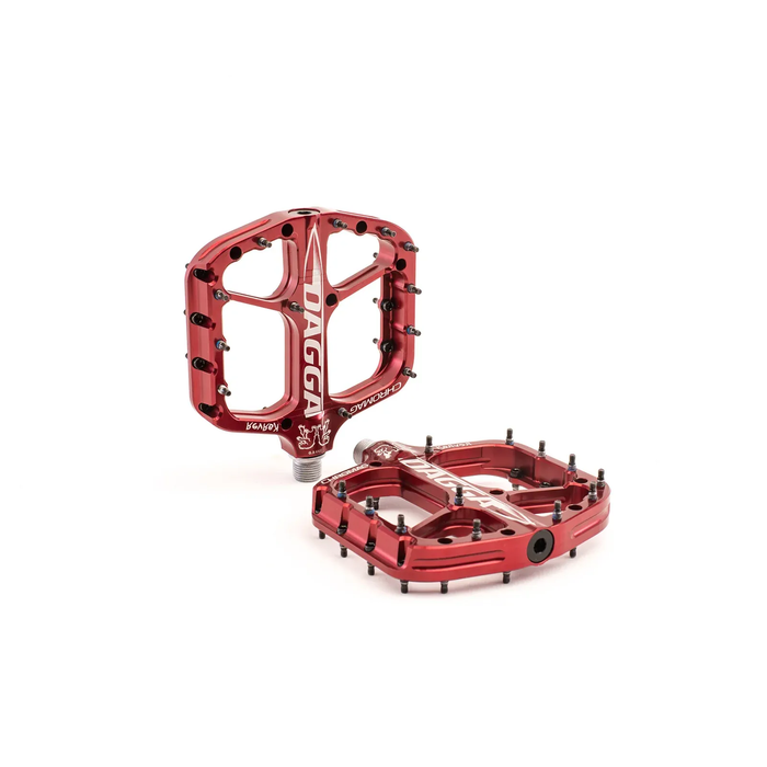 Red bicycle pedals with 'Dagga' branding on a white background