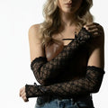 Elegant long lace arm cover gloves in black or white with floral texture, ruffled trim and stretch fit