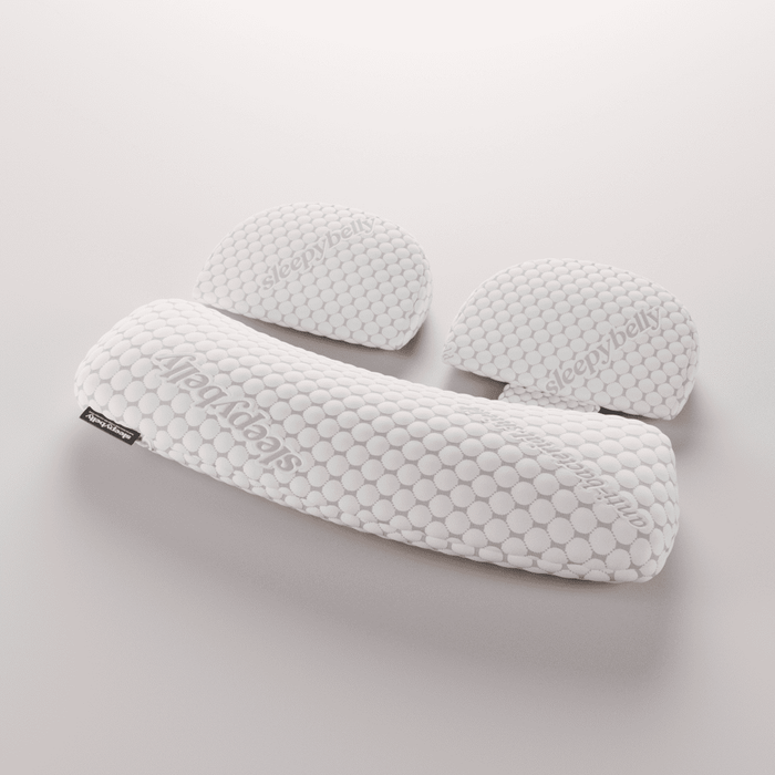 Studio shot of all three Sleepybelly pregnancy pillow pieces dressed in the quilted pillowcase