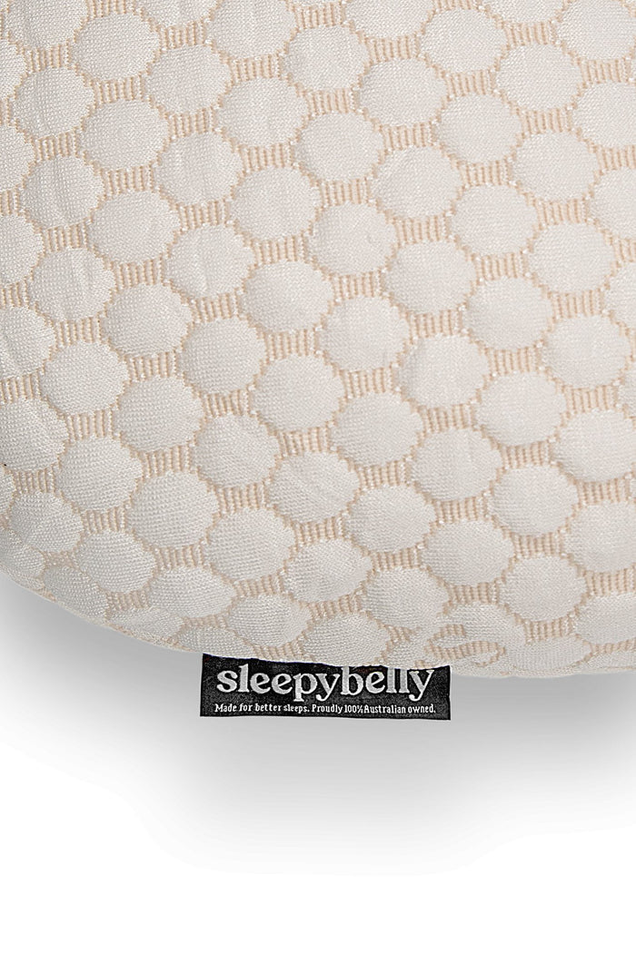 Close-up of the pink Sleepybelly extra pillowcase fabric with brand tag
