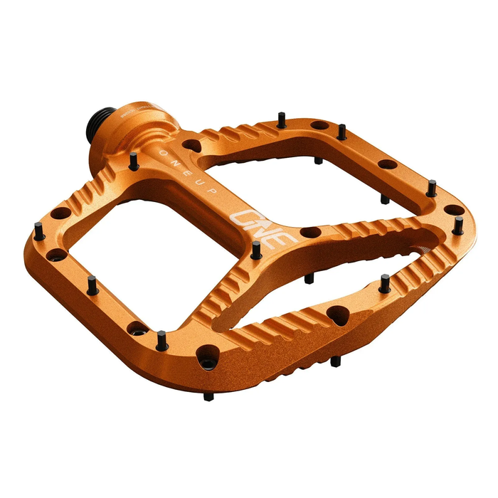 Orange bicycle pedal with 'OneUp' branding on a white background