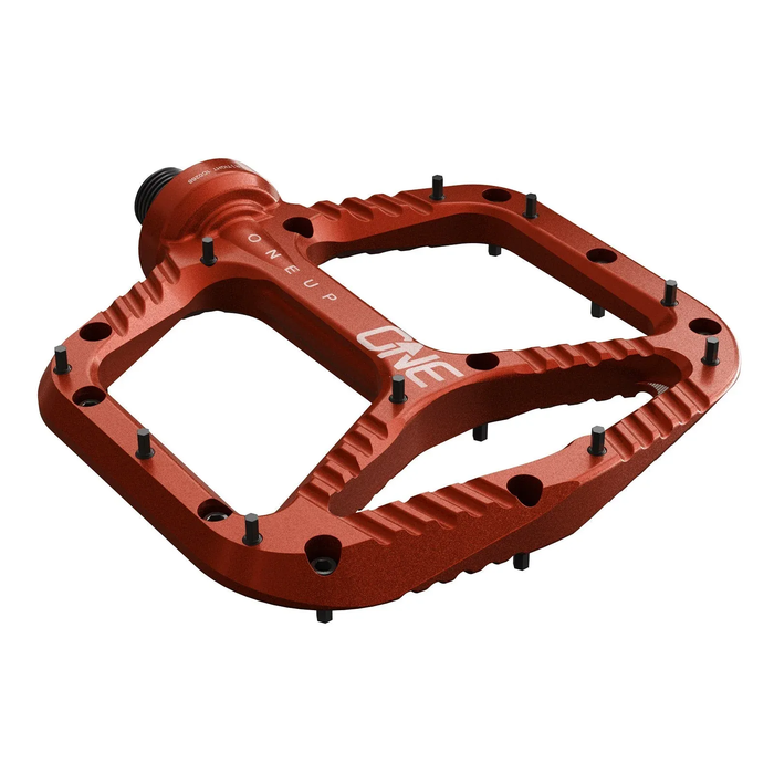 Red bicycle pedal with 'OneUp' branding on a white background