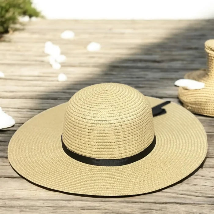 Floppy wide brim straw sun hat with black ribbon band, sustainable braided straw, boho chic summer fashion.