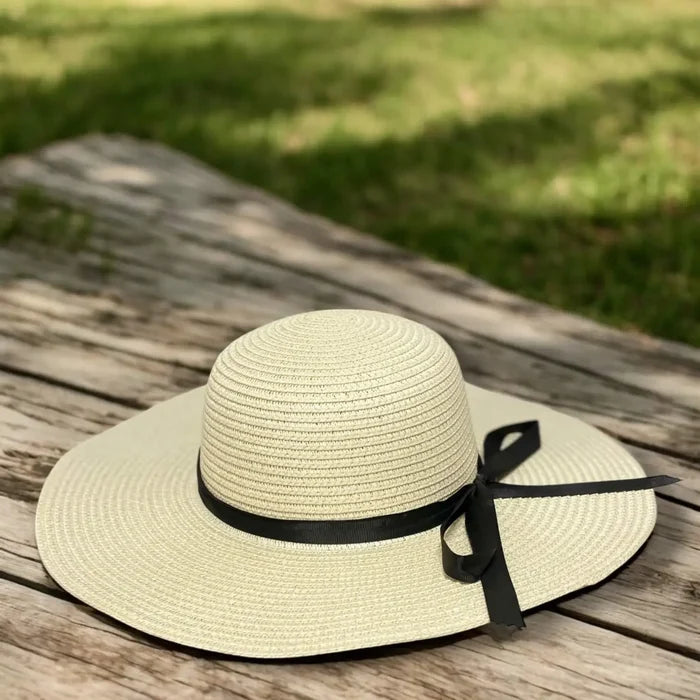 Floppy wide brim straw sun hat with black ribbon band, sustainable braided straw, boho chic summer fashion.