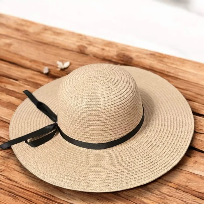 Floppy wide brim straw sun hat with black ribbon band, sustainable braided straw, boho chic summer fashion.