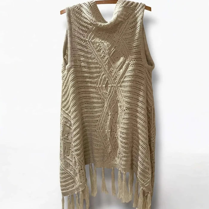 Fringe knitted sleeveless cardigan vest in tan with crochet knit texture, metallic thread accents, open front, and asymmetrical fringe hem