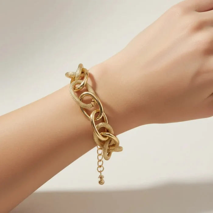Gilded Gold Textured Bold Link Bracelet with chunky intertwined oval links and adjustable lobster clasp being worn