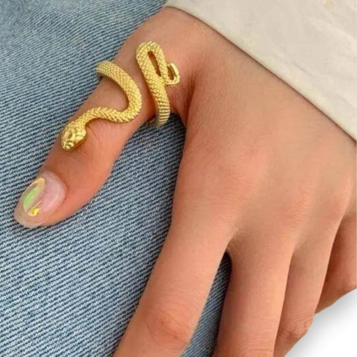 woman wearing on thumb Gold Coiled Snake Wrap Ring with textured serpent detail and adjustable open band
