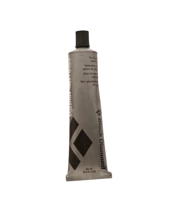 Tube of ski skin adhesive on a white background