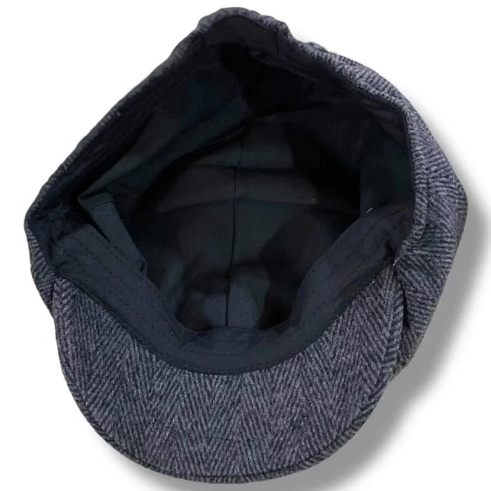 Gray tweed herringbone newsboy cap with short stiff brim and button top, styled as a vintage men’s flat cap.