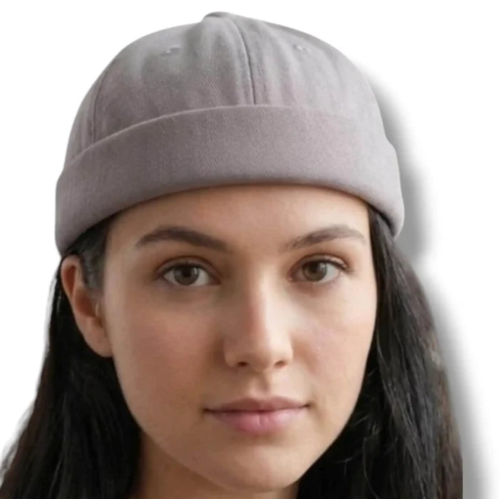 model wearings Harbour Cotton Docker No Brim Cap in gray rolled edge, eyelets, button top, and adjustable strap osfm / unisex