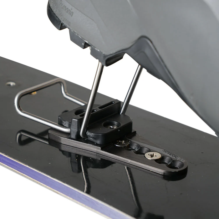 Close-up of a metal bracket attached to a black surface with a white background