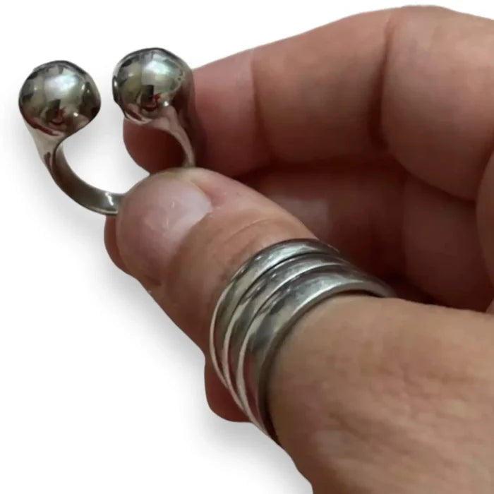 man holding the Heavy Metal Silver Cuff Ring stainless steel double orbs design