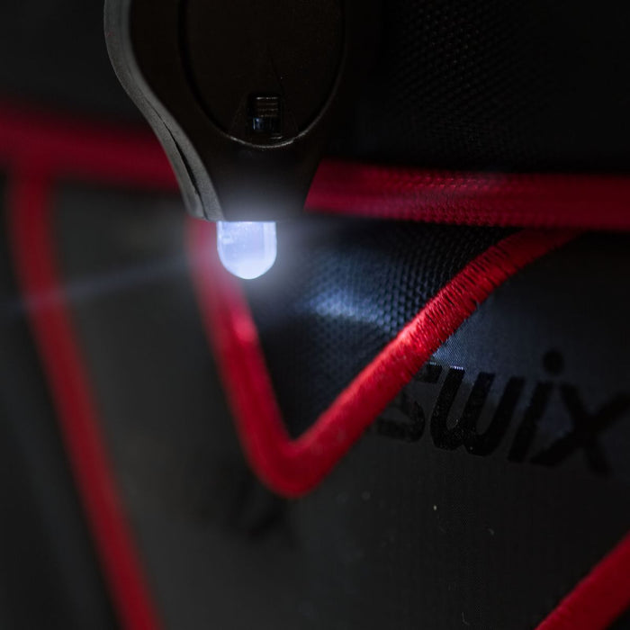 Close-up of a bag with a light on, featuring the brand 'Swix'.