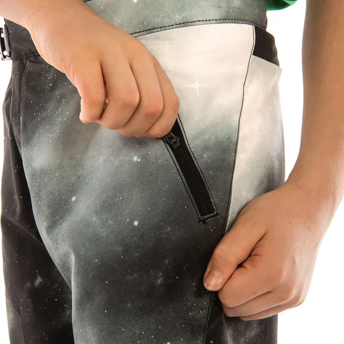 Person wearing a black apron with a white pocket, holding it open.