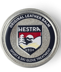 Hestra leather balm container with logo on a transparent background