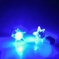 Blue LED light up star stud earrings glowing in solid and flashing modes, festival-ready unisex jewelry.