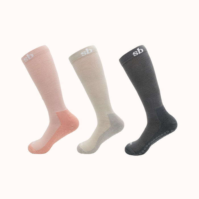 Sleepybelly maternity compression socks in pale pink, grey and charcoal with grip soles
