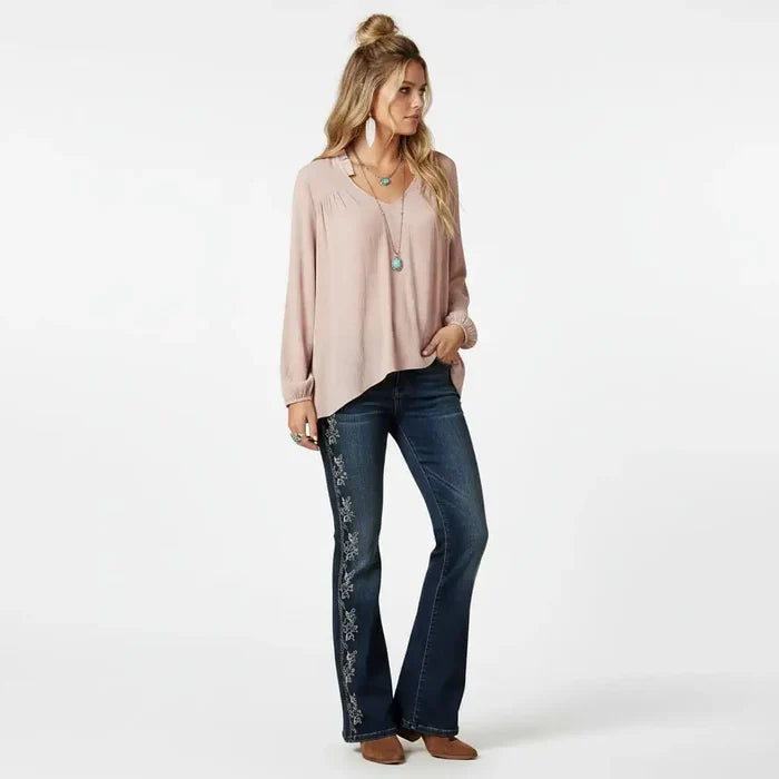 Woman wearing medium Mauve Ruffle V-Neck Long Sleeve Blouse with high-low hem and boho western style