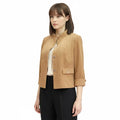 model wearing Modern Minimalist Tan Suede Crop Jacket with mandarin collar and silver button / women's/ medium