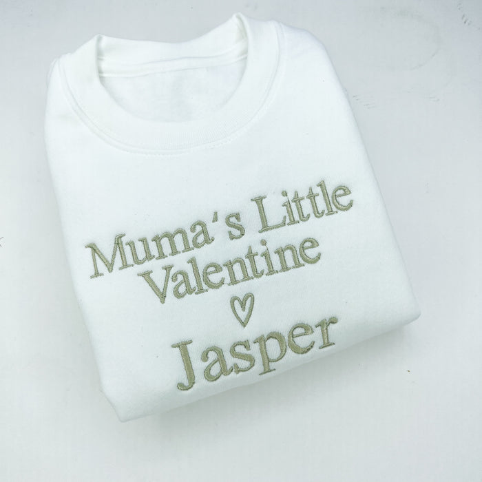 White baby romper with 'Mumma’s Little Valentine Jasper' text on a light gray background